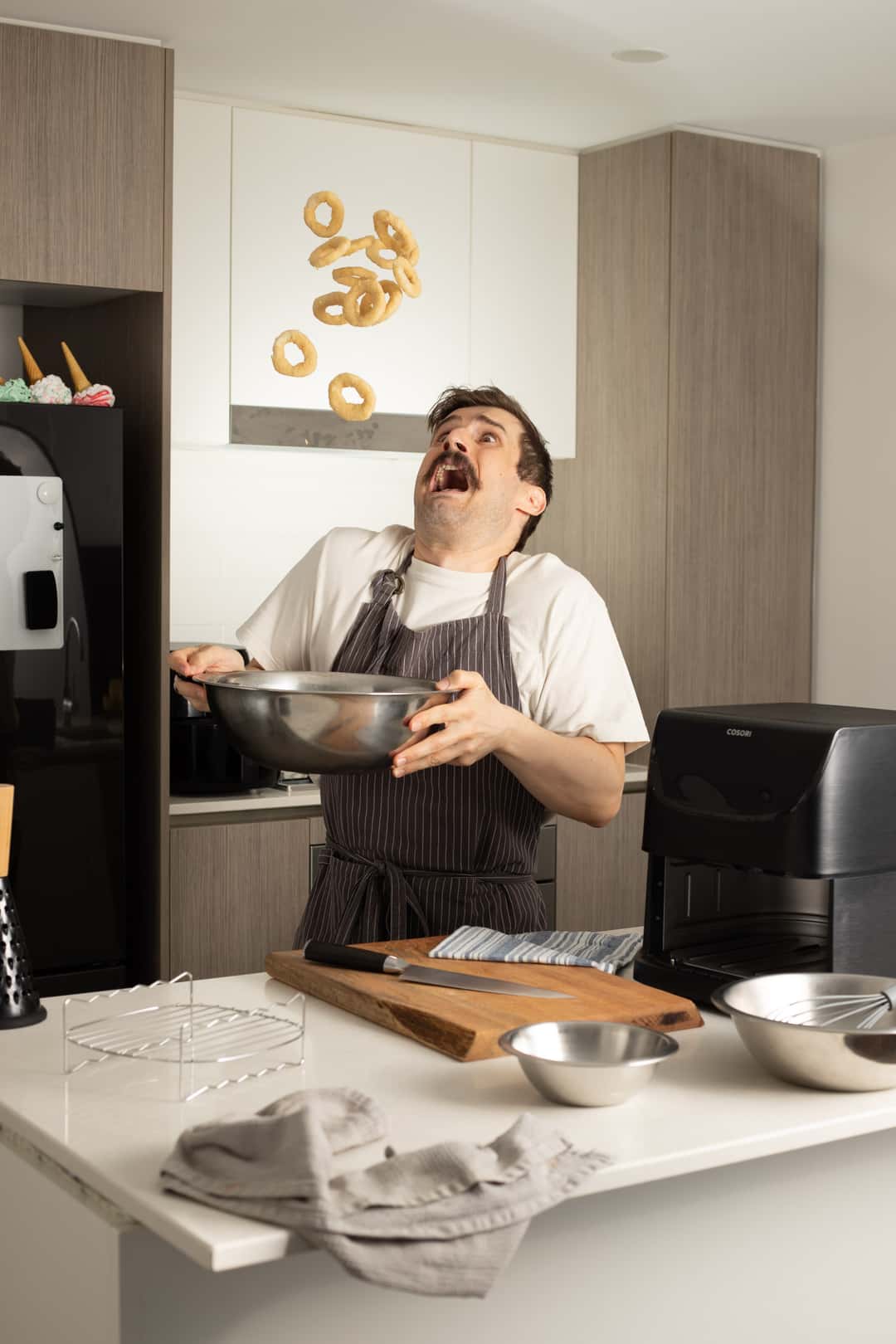 Phil throwing onion rings into the air in a shocking manner